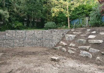 Garden retaining system incorporating gabion cage system and rockery stone to create a unique affect. Example of Landscaping in West Yorkshire